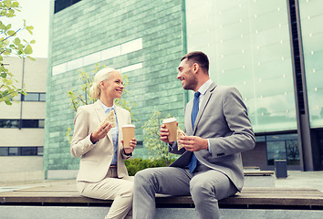 Image showing smiling businessmen with paper cups outdoors