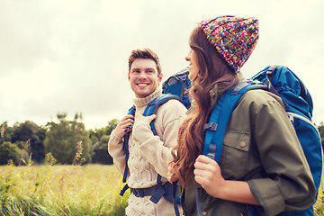 Image showing smiling couple with backpacks hiking