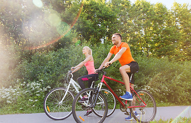 Image showing happy couple riding bicycle outdoors