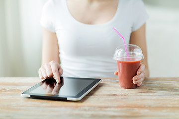 Image showing close up of woman with tablet pc and smoothie