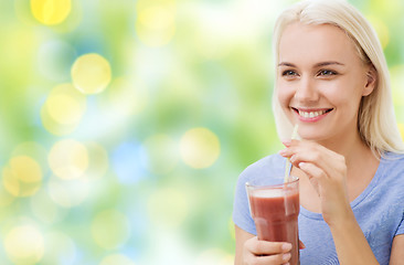 Image showing smiling woman drinking juice or shake