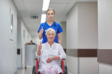 Image showing nurse with senior woman in wheelchair at hospital