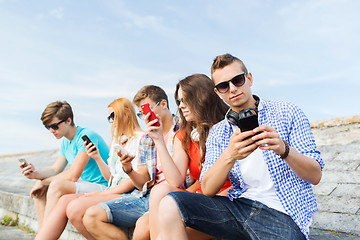 Image showing group of friends with smartphone outdoors