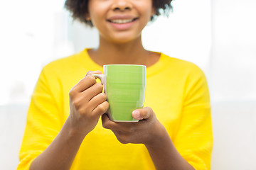 Image showing happy african american woman drinking from tea cup