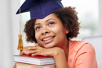 Image showing happy african bachelor girl with books at home