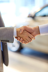 Image showing close up of male handshake in auto show or salon