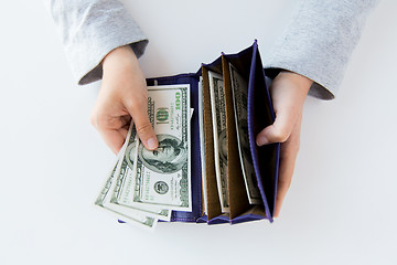 Image showing close up of woman hands with wallet and money