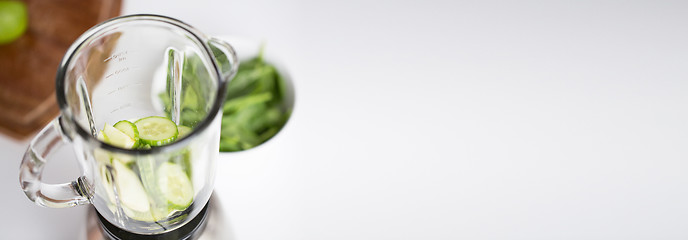 Image showing close up of blender jar and green vegetables