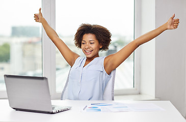 Image showing happy african woman with laptop at office