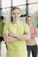 Image showing smiling man and woman in gym