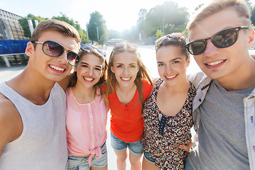 Image showing smiling friends taking selfie