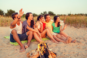 Image showing smiling friends in sunglasses on summer beach