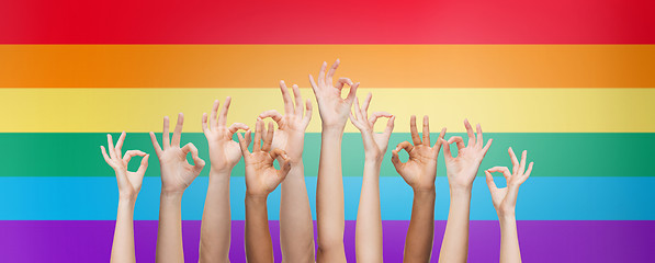 Image showing hands showing ok sign over rainbow background