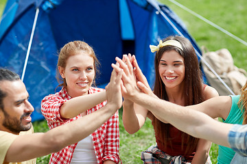 Image showing happy friends making high five at camping