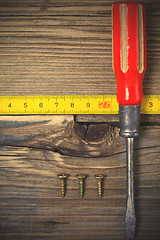 Image showing old screwdriver, screws and measuring lenght