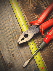 Image showing vintage pliers, old screwdriver and measuring tape