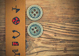 Image showing vintage band with embroidered ornaments and old button