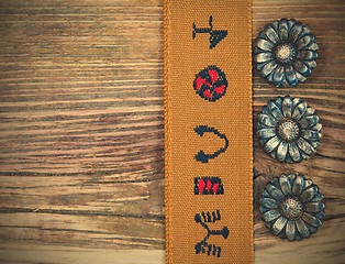 Image showing vintage buttons and old tape with embroidered ornaments