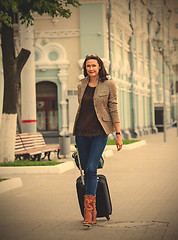 Image showing pretty adult businesswoman with a suitcase