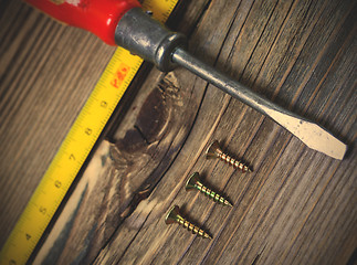 Image showing ancient screwdriver, screws and measuring lenght