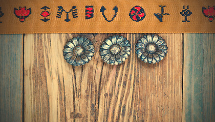 Image showing vintage band with embroidered ornaments and old button