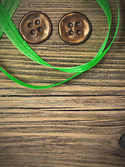 Image showing still life with old green tape and two vintage buttons