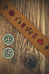 Image showing vintage band with embroidered ornaments and old button