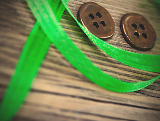 Image showing still life with old green tape and two vintage buttons