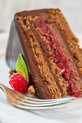 Image showing Piece of chocolate cake with raspberries.