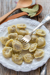 Image showing Dumplings and fork on a plate.