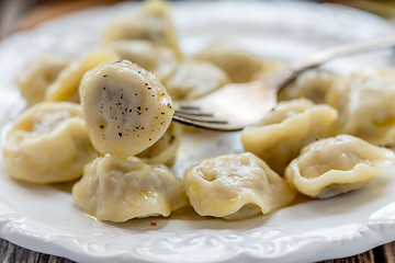 Image showing Dumplings with butter and black pepper.