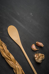 Image showing Wooden spoon and garlic 