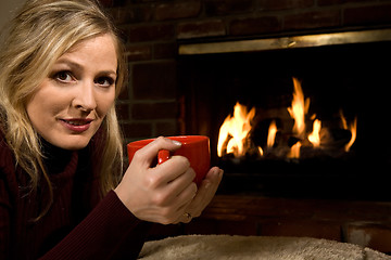 Image showing Warming up by the fire