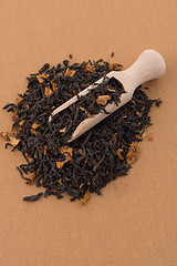 Image showing Black Dry Tea with a Wooden Spoon