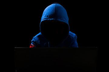 Image showing Faceless Hacker using computer