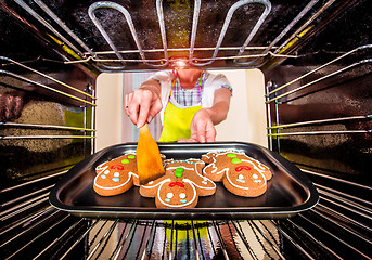 Image showing Baking Gingerbread man in the oven