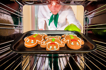 Image showing Baking Gingerbread man in the oven