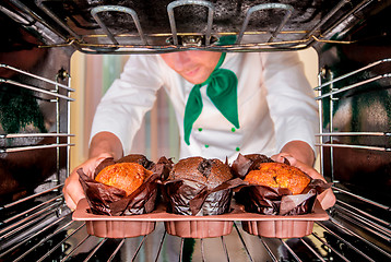 Image showing Baking muffins in the oven