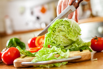 Image showing Woman\'s hands cutting vegetables