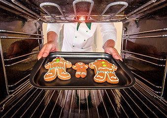 Image showing Baking Gingerbread man in the oven