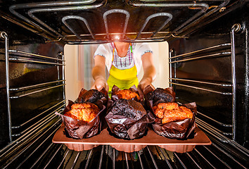 Image showing Baking muffins in the oven