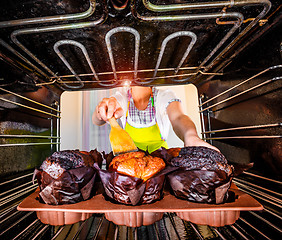 Image showing Baking muffins in the oven