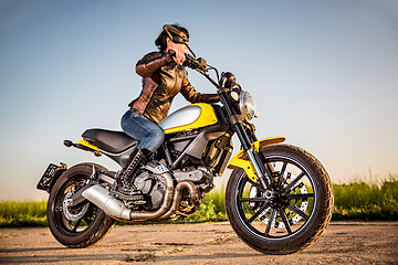 Image showing Biker girl on a motorcycle