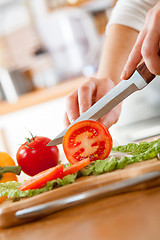 Image showing Woman\'s hands cutting tomato