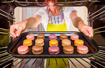 Image showing Baking macarons in the oven.