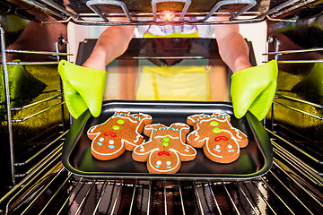 Image showing Baking Gingerbread man in the oven