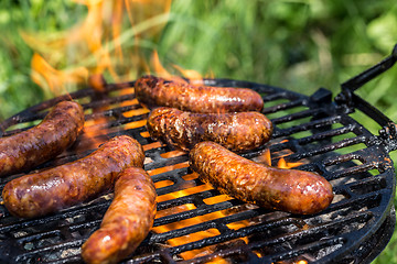 Image showing Grilling sausages