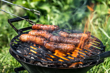 Image showing Grilling sausages