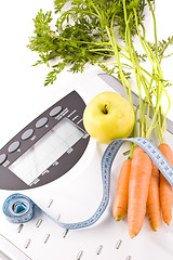 Image showing carrots, apple and measuring objects