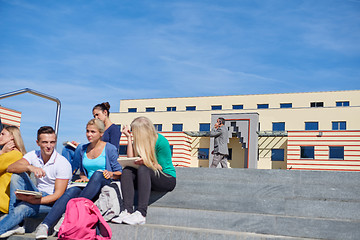 Image showing students outside sitting on steps